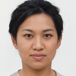 Joyful asian young-adult female with short  brown hair and brown eyes