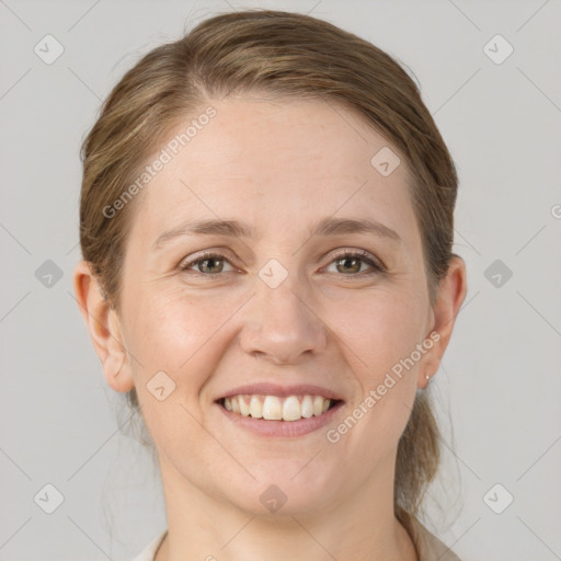 Joyful white adult female with medium  brown hair and grey eyes