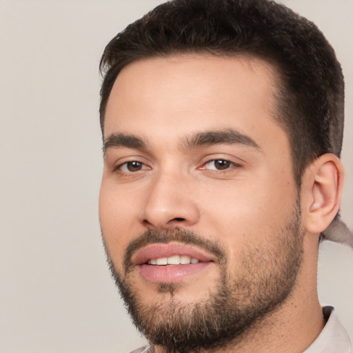 Joyful white young-adult male with short  black hair and brown eyes