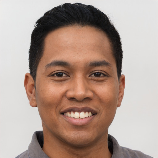 Joyful asian young-adult male with short  black hair and brown eyes