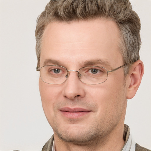 Joyful white adult male with short  brown hair and grey eyes