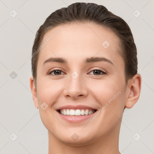 Joyful white young-adult female with short  brown hair and brown eyes