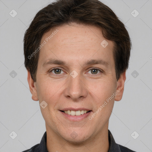 Joyful white adult male with short  brown hair and grey eyes