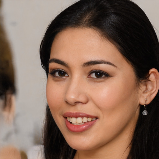 Joyful latino young-adult female with long  brown hair and brown eyes