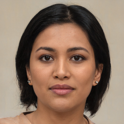 Joyful latino young-adult female with medium  black hair and brown eyes