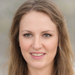 Joyful white young-adult female with long  brown hair and green eyes