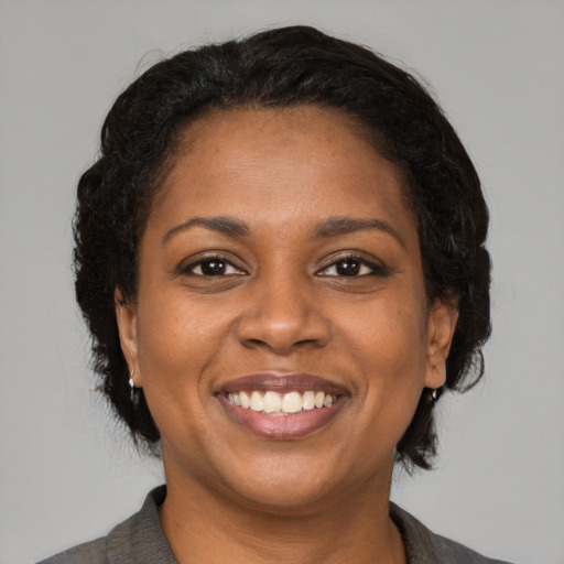 Joyful latino young-adult female with medium  black hair and brown eyes