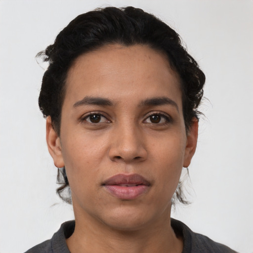 Joyful latino young-adult female with short  black hair and brown eyes