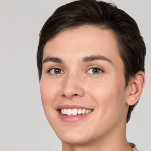 Joyful white young-adult female with short  brown hair and brown eyes