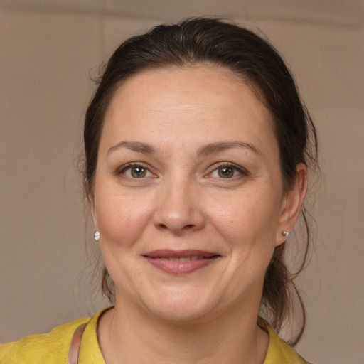 Joyful white adult female with medium  brown hair and brown eyes