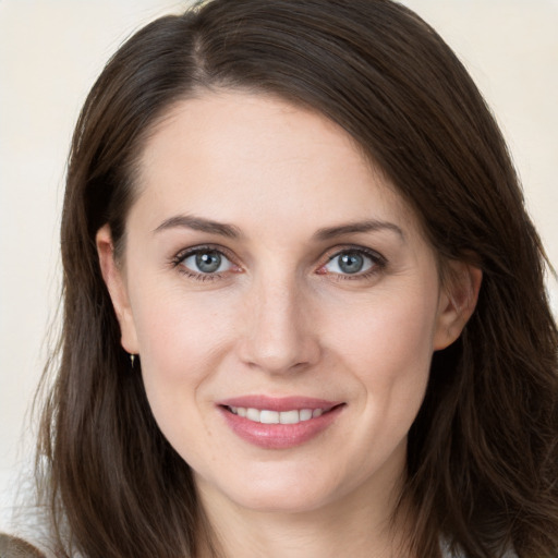 Joyful white young-adult female with long  brown hair and grey eyes