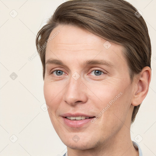 Joyful white adult male with short  brown hair and grey eyes