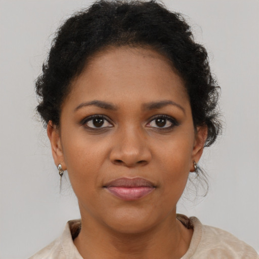 Joyful black young-adult female with short  brown hair and brown eyes