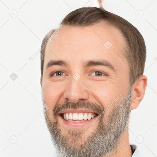 Joyful white adult male with short  brown hair and brown eyes