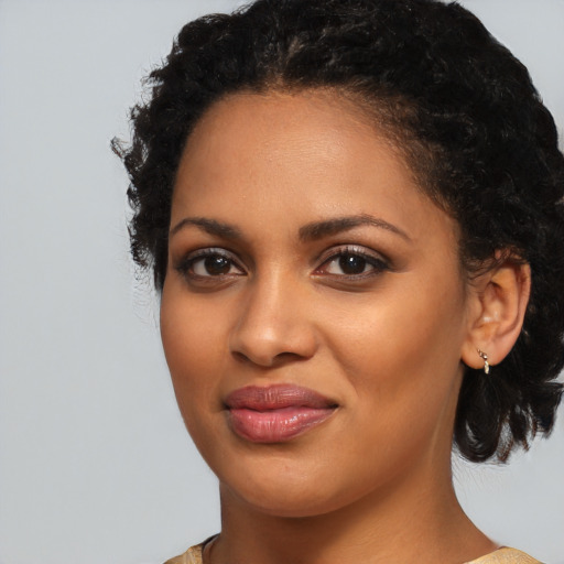 Joyful black young-adult female with medium  black hair and brown eyes
