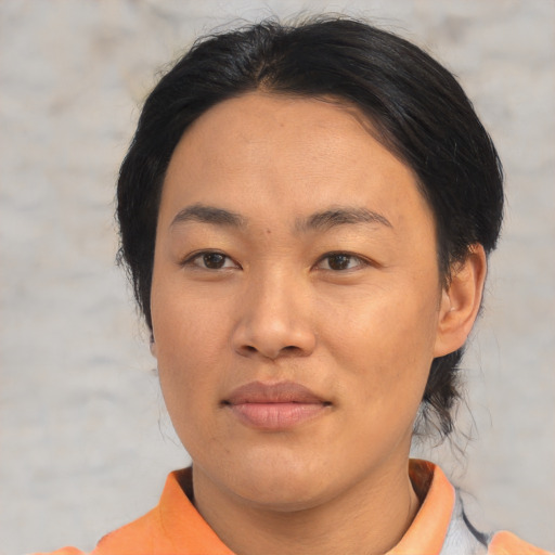 Joyful asian adult female with short  brown hair and brown eyes