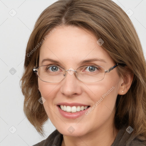 Joyful white adult female with medium  brown hair and blue eyes