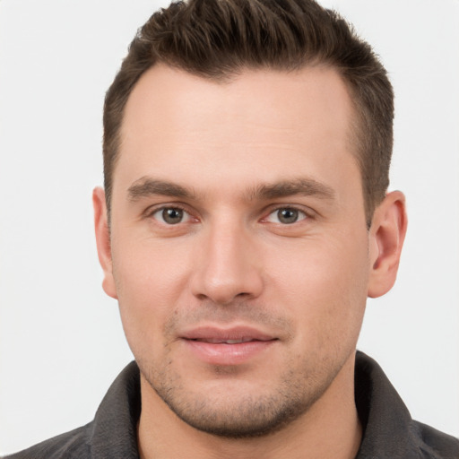 Joyful white young-adult male with short  brown hair and brown eyes