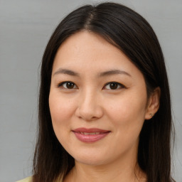 Joyful asian young-adult female with long  brown hair and brown eyes