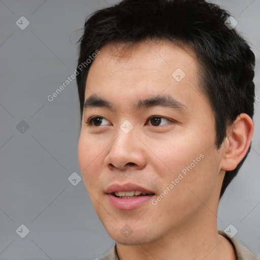 Joyful asian young-adult male with short  black hair and brown eyes