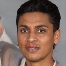 Joyful latino young-adult male with short  brown hair and brown eyes