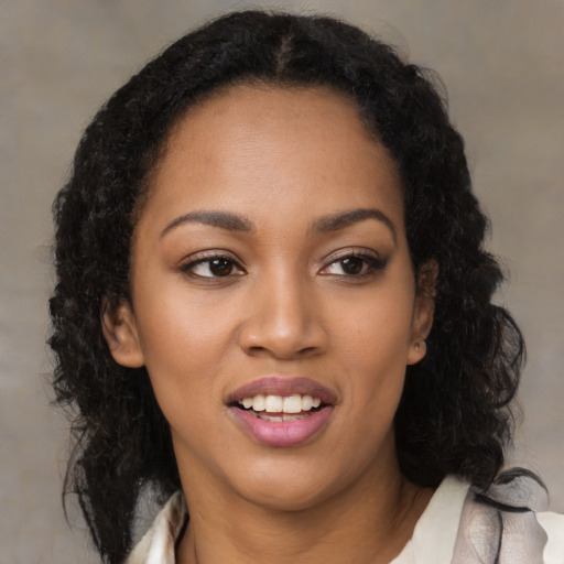 Joyful black young-adult female with medium  black hair and brown eyes