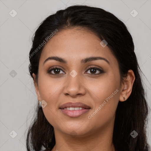 Joyful latino young-adult female with long  brown hair and brown eyes