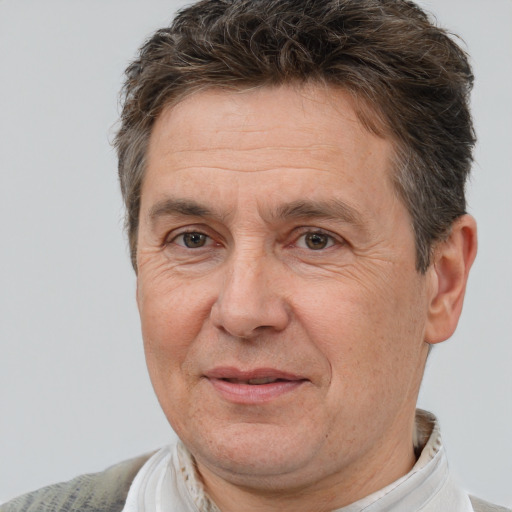 Joyful white middle-aged male with short  brown hair and brown eyes