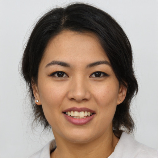 Joyful asian young-adult female with medium  brown hair and brown eyes