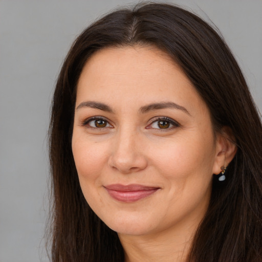 Joyful white young-adult female with long  brown hair and brown eyes