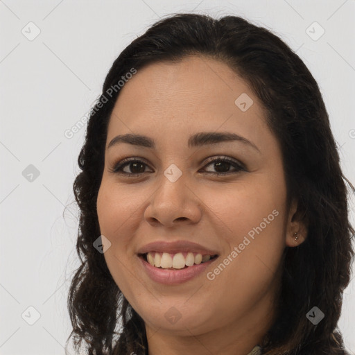 Joyful latino young-adult female with long  brown hair and brown eyes