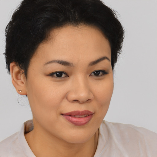 Joyful asian young-adult female with short  brown hair and brown eyes