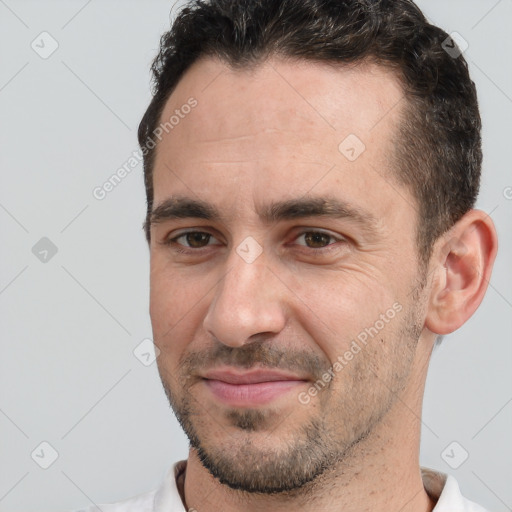 Joyful white adult male with short  brown hair and brown eyes