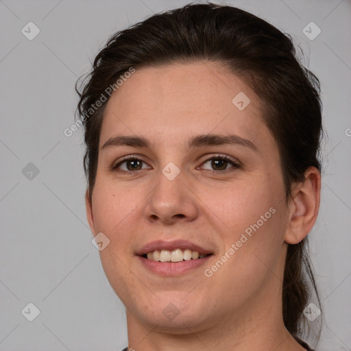 Joyful white young-adult female with medium  brown hair and brown eyes