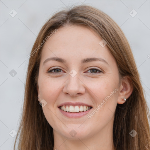 Joyful white young-adult female with long  brown hair and grey eyes