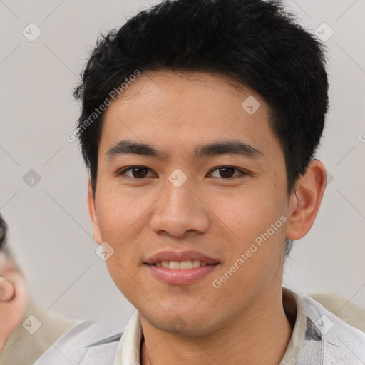 Joyful asian young-adult male with short  black hair and brown eyes