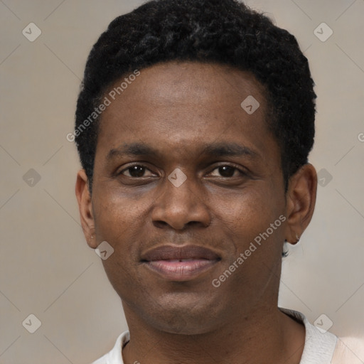 Joyful black young-adult male with short  black hair and brown eyes