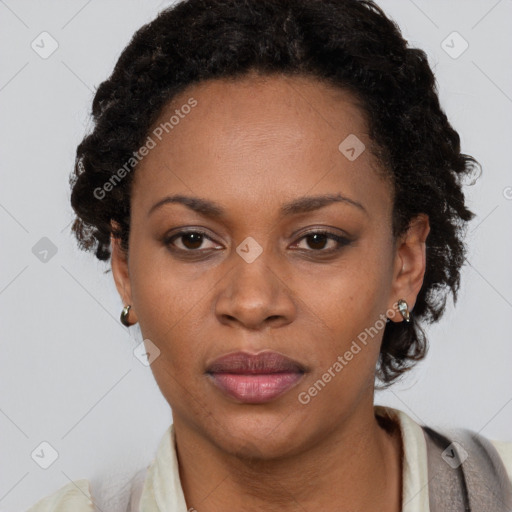 Joyful black adult female with short  black hair and brown eyes