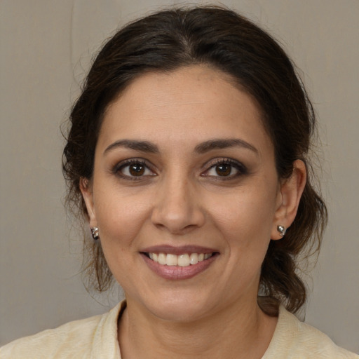 Joyful white adult female with medium  brown hair and brown eyes