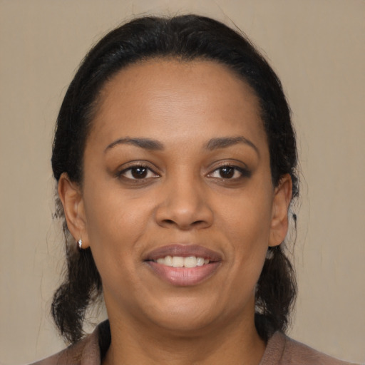 Joyful black young-adult female with medium  brown hair and brown eyes
