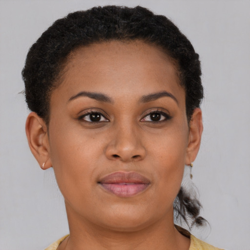 Joyful black young-adult female with short  brown hair and brown eyes