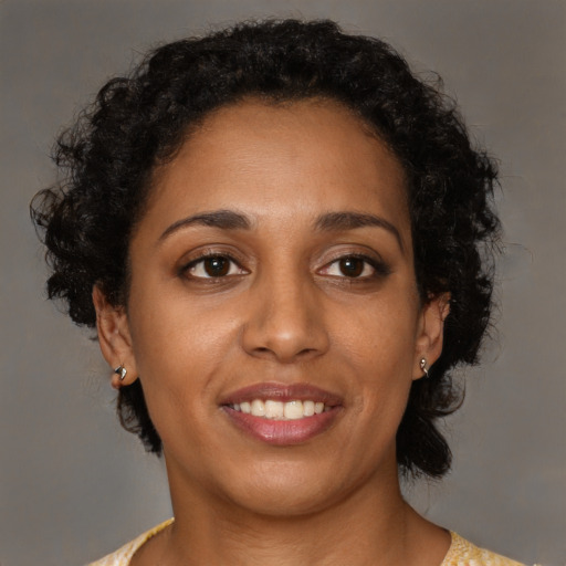 Joyful black young-adult female with medium  brown hair and brown eyes