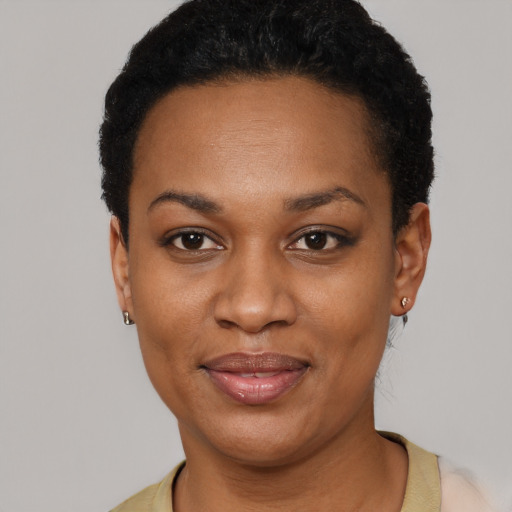 Joyful black adult female with short  black hair and brown eyes