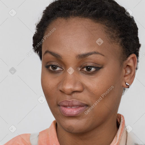 Joyful black young-adult female with short  brown hair and brown eyes