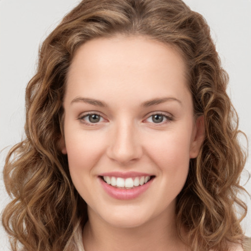 Joyful white young-adult female with long  brown hair and green eyes