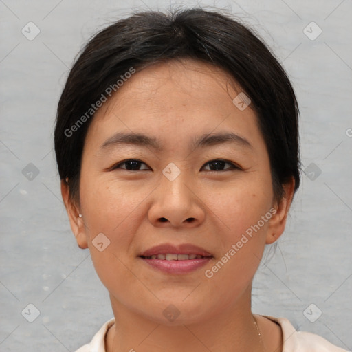 Joyful asian young-adult female with short  brown hair and brown eyes