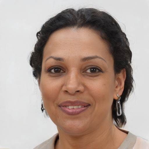 Joyful latino adult female with short  brown hair and brown eyes