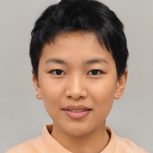 Joyful asian child female with short  brown hair and brown eyes