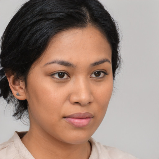 Joyful latino young-adult female with medium  brown hair and brown eyes
