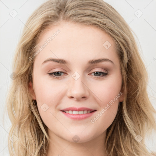 Joyful white young-adult female with long  brown hair and blue eyes